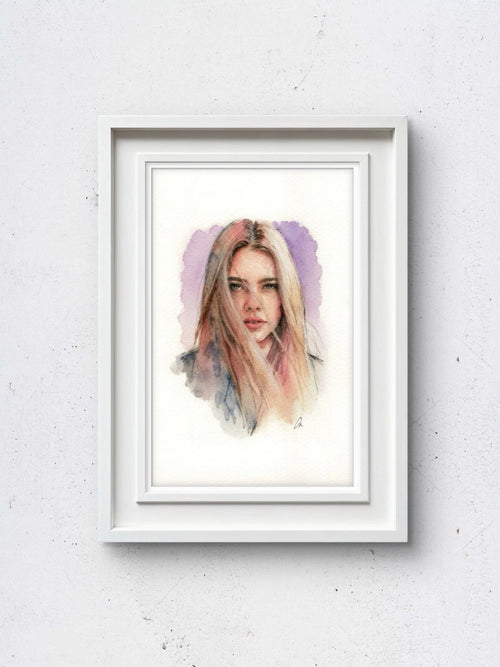 White-framed portrait of a woman in flowing light pink-blonde hair, set against a plain light background.