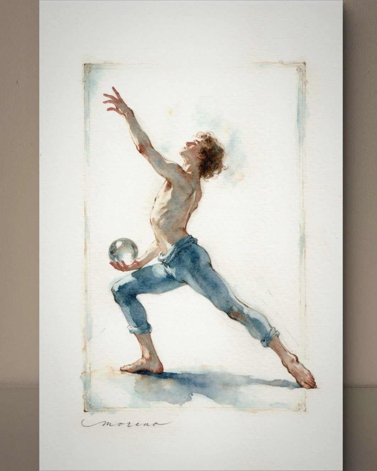 Male dancer in light blue jeans stretching to catch a glass sphere on his hands, framed by vertical watercolor stripes.